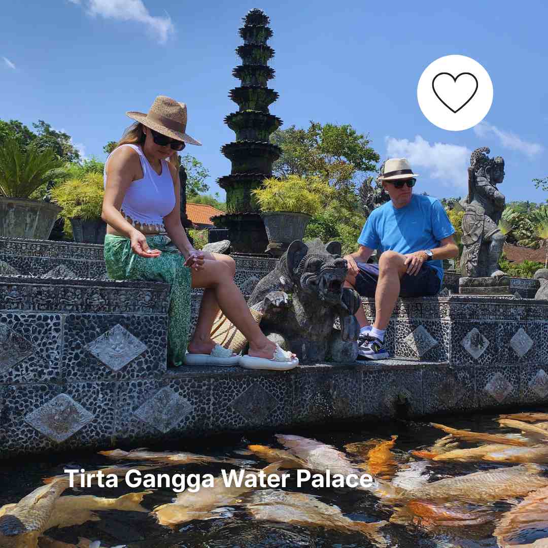 A Couple Fiding Koi Fish At Tirta Gangga Water Palace